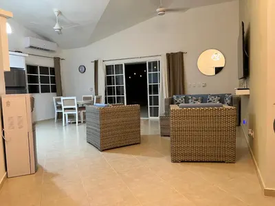 a living room with wicker chairs and a table at Villa 156, 3 bedrooms and 3 bathrooms with private pool in Sosúa