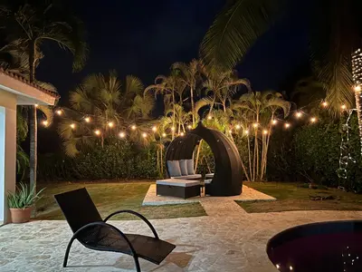 a patio at night with lights and a couch at Villa 156, 3 bedrooms and 3 bathrooms with private pool in Sosúa