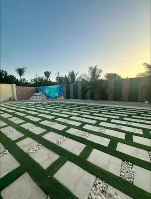 a garden with grass and rocks on the ground at Villa Lujosa en Boca Chica in Cuevas