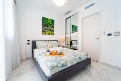 a bedroom with a bed with a tray of fruit on it at Vista Relax Golf & Pool View @ Cana Rock Star 210 in Punta Cana