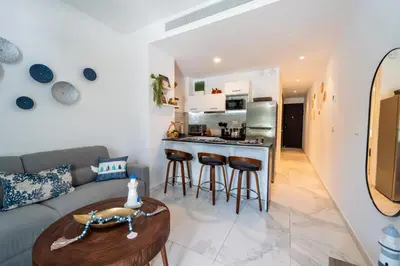 a living room with a couch and a table at Aqua Fam Swim out Suite - Pool @ Cana Rock G 117 in Punta Cana