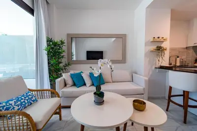 a living room with a couch and a table at Directo piscina jardín terraza @ Cana Rock in Punta Cana