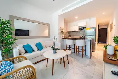 a living room with a couch and a table at Directo piscina jardín terraza @ Cana Rock in Punta Cana