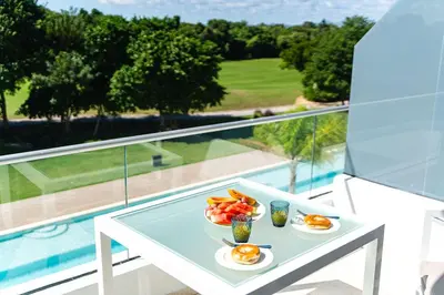 a table with plates of eggs and fruit on a balcony at Single Loft Best Pool Views! Cana Rock Star G-205 in Punta Cana
