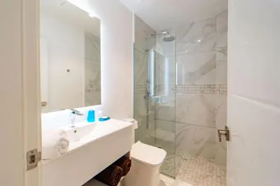 a white bathroom with a sink and a shower at Single Loft Best Pool Views! Cana Rock Star G-205 in Punta Cana