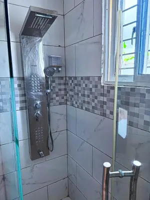 a shower with a shower head in a bathroom at Cozy 2 Bedroom Apartment Boca Chica in Boca Chica