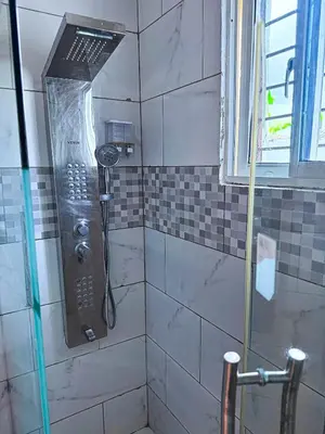 a shower with a shower head in a bathroom at Cozy 2 Bedroom Apartment Boca Chica in Boca Chica