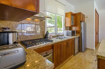 a kitchen with a stove top oven next to a sink at Luxury Ocean View Villa in Sosua Ocean Village in Sosúa