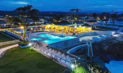 an aerial view of a resort pool at night at Sea La Vie Villa in Oceanfront Sosua Ocean Village in Sosúa
