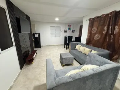 a living room with two couches and a table at Apartmento Las Palmeras 1 A1 in Vicente Noble