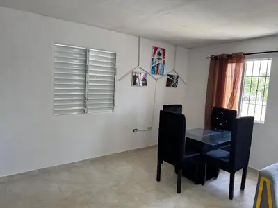 a dining room with a table and two chairs at Apartmento Las Palmeras 1 A1 in Vicente Noble
