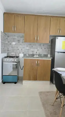a kitchen with a stove and a refrigerator at 4 vecinos in Santiago de los Caballeros