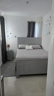 a bedroom with a large bed with blue stars on the wall at 4 vecinos in Santiago de los Caballeros