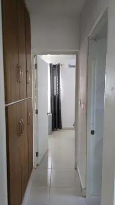 a room with a hallway with a door to a bathroom at 4 vecinos in Santiago de los Caballeros