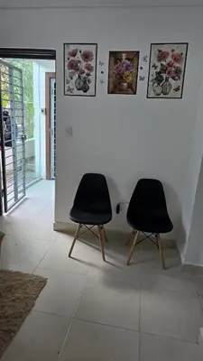 two black chairs sitting in a room at 4 vecinos in Santiago de los Caballeros