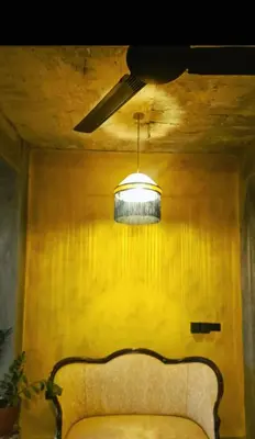 a room with a couch and a light hanging from a ceiling at Casba Hostel in Las Terrenas