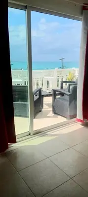 a balcony with a view of the ocean from a window at Marinero de ensueño in Las Terrenas