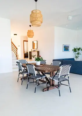 a dining room with a wooden table and chairs at Private Villa-Infinity Pool-26 guests capacity-14 King Size Beds-8 bedrooms-8 and half baths in Cabrera