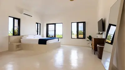 a white bedroom with a bed and windows at Private Villa-Infinity Pool-26 guests capacity-14 King Size Beds-8 bedrooms-8 and half baths in Cabrera