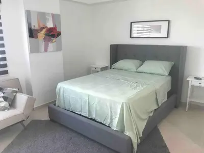 a bedroom with a bed and a couch at Eclectic 3 levels and 5 bedrooms penthouse in Santo Domingo