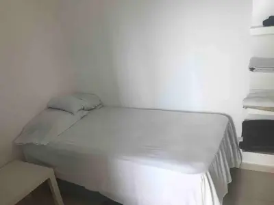 a white bed in a room with a table at Eclectic 3 levels and 5 bedrooms penthouse in Santo Domingo