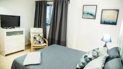 a bedroom with a bed and a tv and a couch at 3 levels and 5 bedrooms penthouse with a great view in Santo Domingo