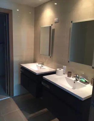 a bathroom with two sinks and a mirror at 3 levels and 5 bedrooms penthouse with a great view in Santo Domingo