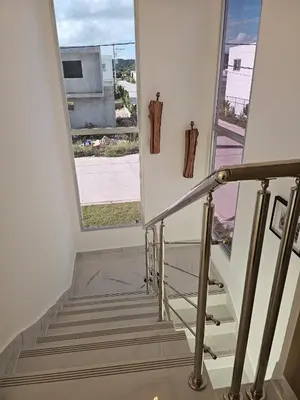 a staircase with a large window and a stair case at Villa Carpe Diem in Punta Cana