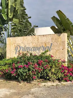 a sign for the entrance to a resort with pink flowers at Villa Carpe Diem in Punta Cana