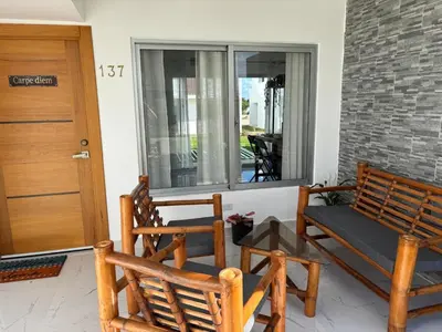 a porch with two rocking chairs and a window at Villa Carpe Diem in Punta Cana