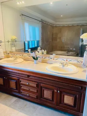 a bathroom with two sinks and a large mirror at Vista al mar Hab Privada Larimar, Malecon Santo D in Santo Domingo