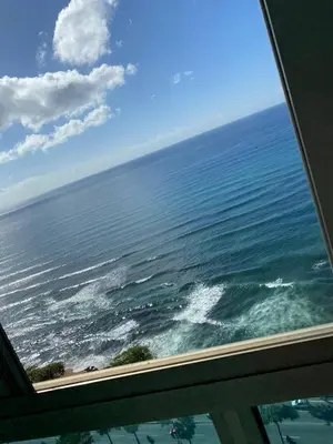 a view of the ocean from a window at Vista al mar Hab Privada Larimar, Malecon Santo D in Santo Domingo