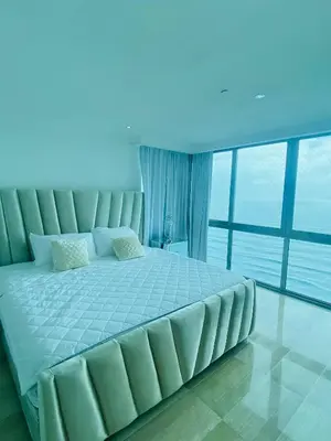 a large bed in a room with a large window at Vista al mar Hab Privada Larimar, Malecon Santo D in Santo Domingo