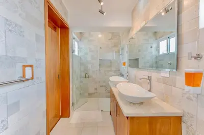 a bathroom with two sinks and a shower at 5bd Villa in Oceanfront Community Sosua Ocean Village in Sosúa