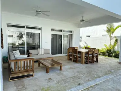 a living room with a couch and a table and chairs at Villa Solana in Oceanfront Com Sosua Ocean Village in Sosúa