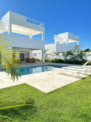 a villa with a swimming pool and a house at Villa Solana in Oceanfront Com Sosua Ocean Village in Sosúa
