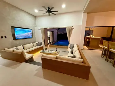 a living room with couches and a ceiling fan at Coral Villa in Oceanfront Comm Sosua Ocean Village in Sosúa