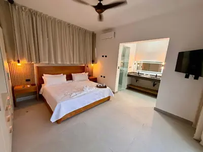 a bedroom with a large bed and a large window at Coral Villa in Oceanfront Comm Sosua Ocean Village in Sosúa