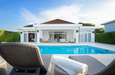 a villa with a swimming pool and a house at Ocean View Villa in Oceanfront Sosua Ocean Village in Sosúa