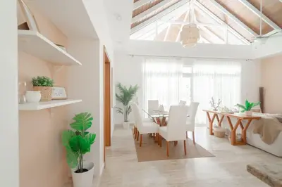 a dining room with a table and white chairs at Ocean View Villa in Oceanfront Sosua Ocean Village in Sosúa