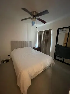 a bedroom with a bed with a ceiling fan at Romana Residence Vacationing Apartment in Cumayasa Kilómetros Diez