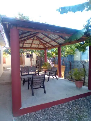 a group of benches sitting under a pavilion at Mi refugio 2 in San Fernando de Monte Cristi