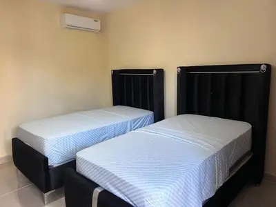 two beds sitting next to each other in a room at Mi refugio 2 in San Fernando de Monte Cristi