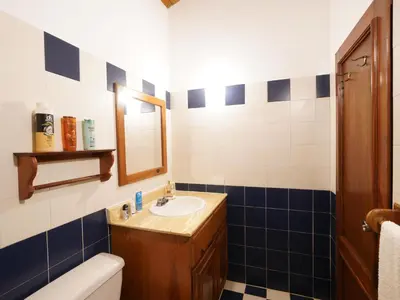 a bathroom with a sink and a toilet and a mirror at Villa silenziosa e sicura al centro di Las Galeras in Las Galeras