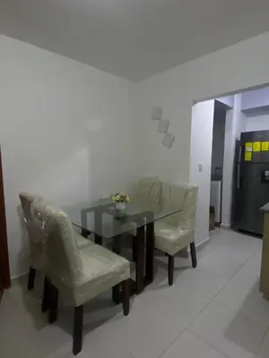 a dining room with a table and two chairs at Cozy 3br apartment near to airport & beaches in La Cana