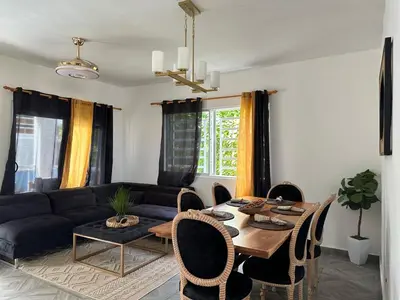 a living room with a table and a couch at Villa kiyana-14 pax, 5min de la playa en Las Galeras in Las Galeras