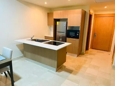 a kitchen with a sink and a refrigerator at Marien Residences 221 Garden & Partial Ocean View Condo in Puerto Plata