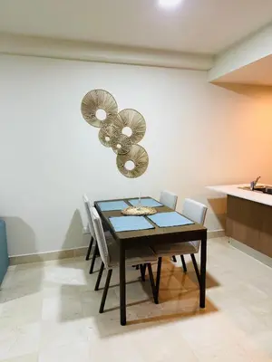 a dining room with a table and some chairs at Marien Residences 221 Garden & Partial Ocean View Condo in Puerto Plata