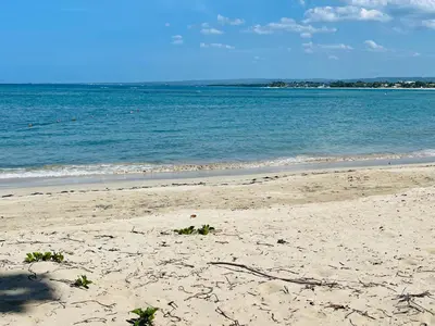 a sandy beach with the ocean in the background at Marien Residences 221 Garden & Partial Ocean View Condo in Puerto Plata