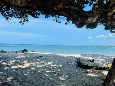 a sandy beach with the ocean in the background at Marien Residences 221 Garden & Partial Ocean View Condo in Puerto Plata